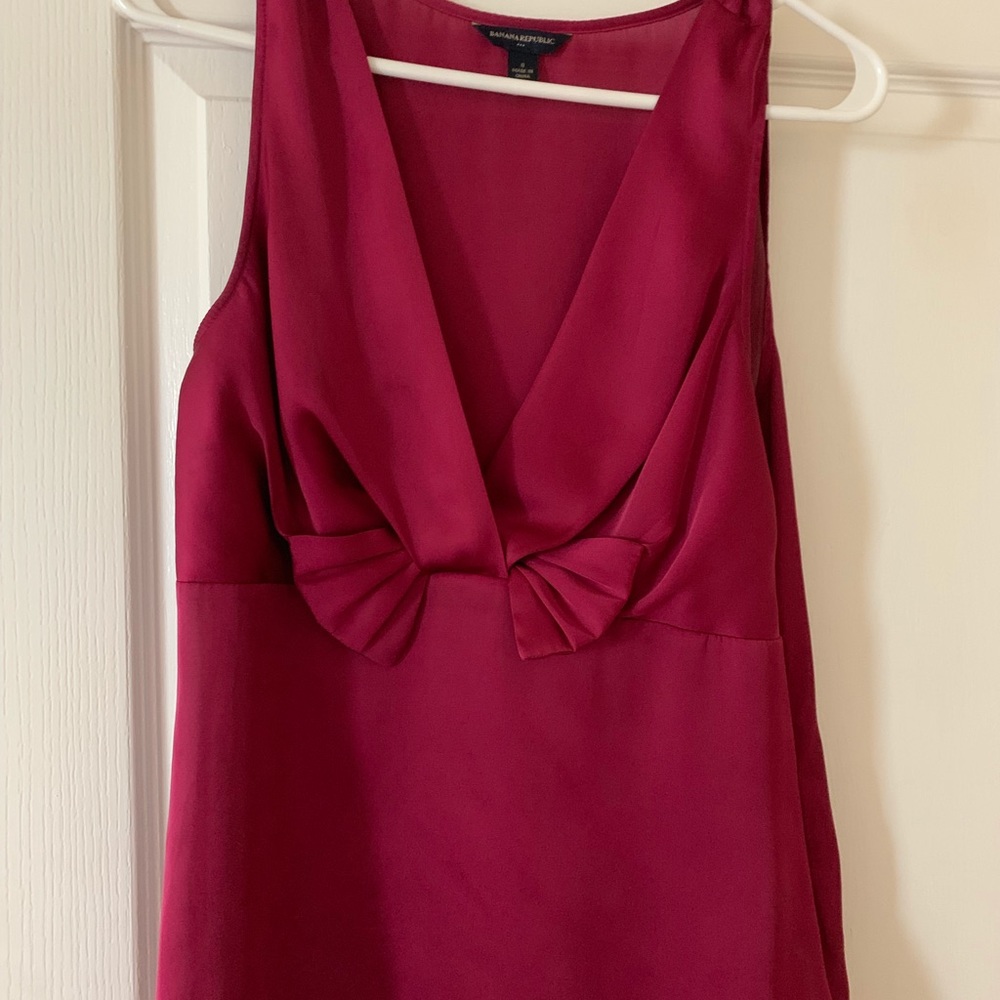 Pink v-neck sleeveless blouse.